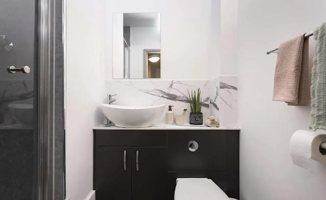 Modern vanity sink and toilet with marble accents bathroom at New Medlock House in Manchester Student Accommodation