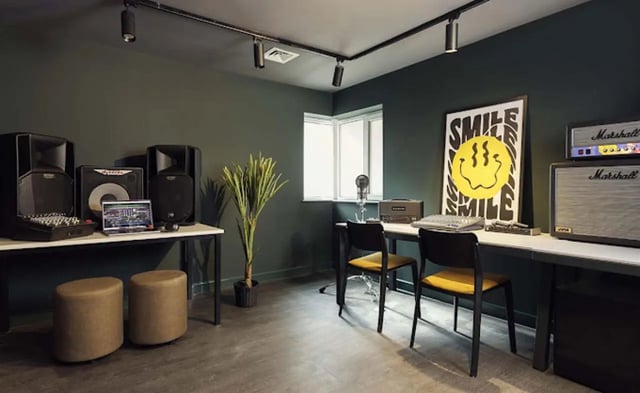 Speakers laptop amplifier poster and chairs studio at New Medlock House in Manchester Student Accommodation