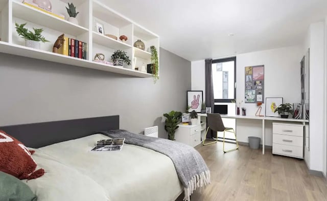 Bed shelves desk and chair bedroom at Parkway Gate in Manchester Student Accommodation