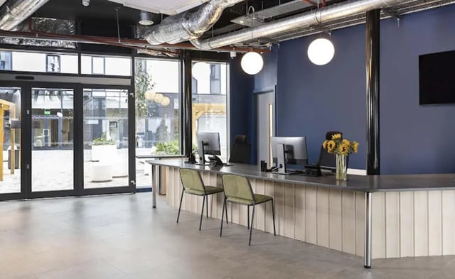 Reception desk with computers and chairs reception area at Parkway Gate in Manchester Student Accommodation