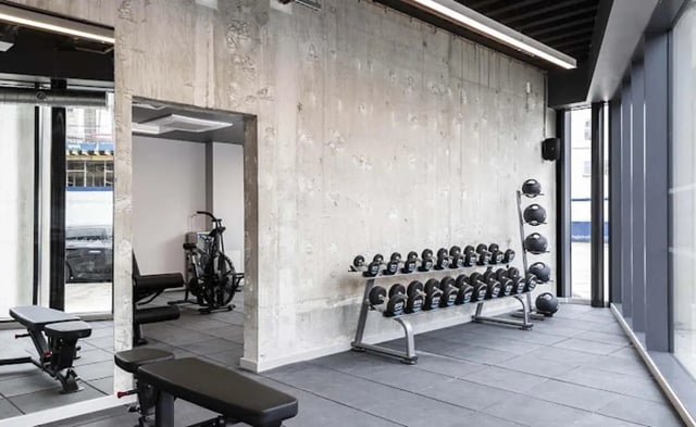 Dumbbells exercise bike gym benches gym area at Parkway Gate in Manchester Student Accommodation