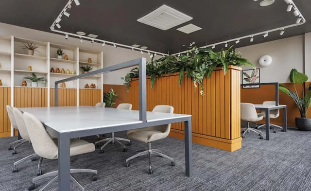 Meeting room with tables chairs and plants study area at Parkway Gate in Manchester Student Accommodation