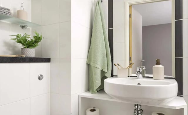 Sink towel toiletries soap plant bathroom at Piccadilly Point in Manchester Student Accommodation