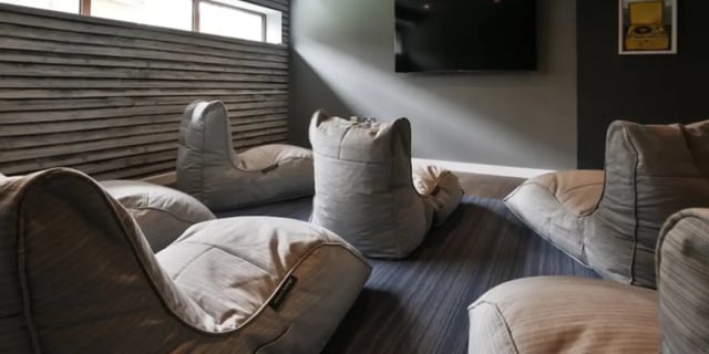 Multiple beanbag chairs on striped rug lounge room at One & Two Victoria Point in Manchester Student Accommodation