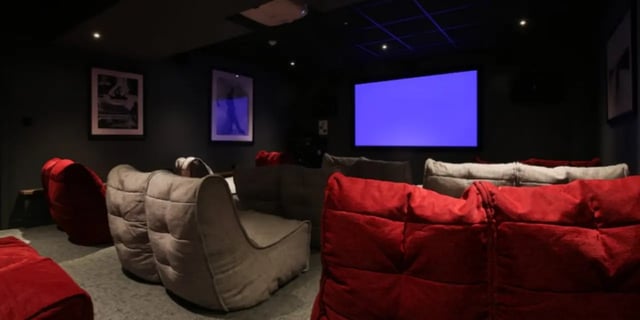 Beanbag chairs screen and framed art playing area at One & Two Victoria Point in Manchester Student Accommodation