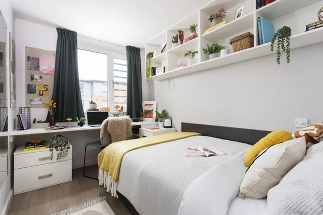 Bed desk shelves plants and curtains bedroom at Kincardine Court in Manchester Student Accommodation
