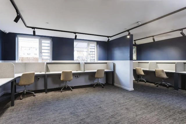 Desks and chairs in a modern study area. at Kincardine Court in Manchester Student Accommodation