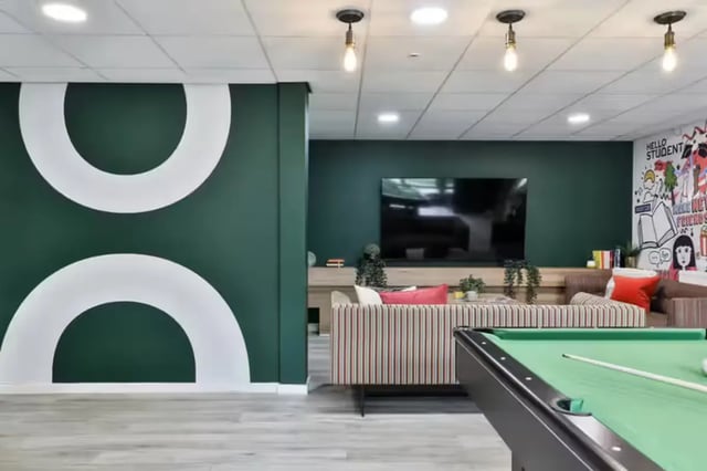 Pool table, couch, TV, mural, communal area at Foss Studios in York Student Accommodation