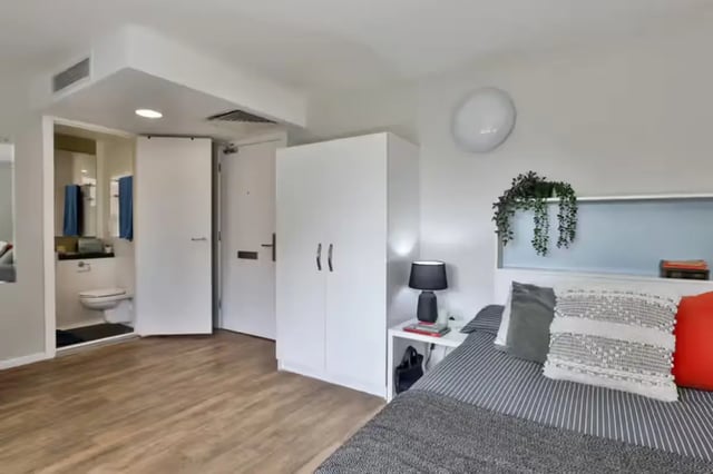 Bedroom with bed wardrobe and bathroom at Foss Studios in York Student Accommodation