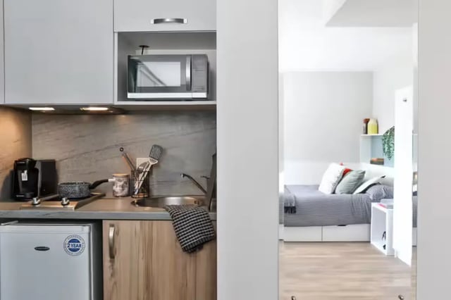 Microwave small fridge sink and bed bedroom at Foss Studios in York Student Accommodation