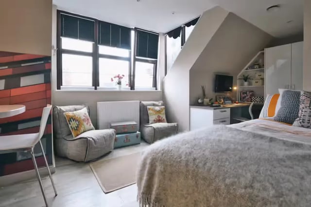 Bed study area desk with monitor and shelves living room at The Frontage in Nottingham Student Accommodation