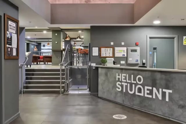 Reception desk with stairs and lift lobby at The Frontage in Nottingham Student Accommodation