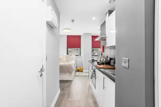 Bed kitchen with red blinds studio apartment at Northgate House Apartments in Cardiff Student Accommodation