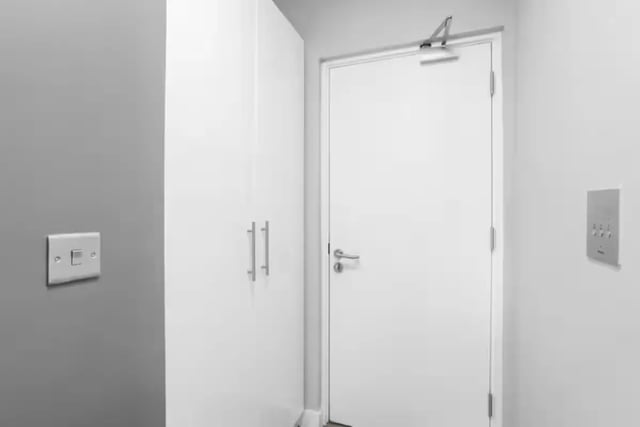 White wardrobe white door light switch intercom panel hallway at Northgate House Apartments in Cardiff Student Accommodation