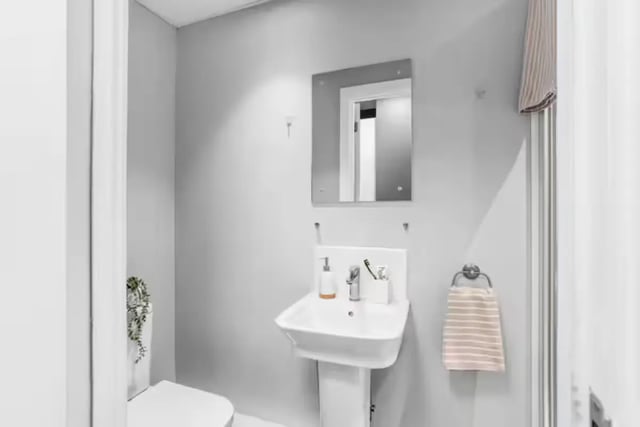 Sink mirror towel and toilet bathroom at Northgate House Apartments in Cardiff Student Accommodation