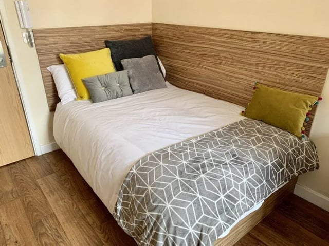 Bed with multiple pillows and patterned throw Bedroom at Trinity Hall in Chester Student Accommodation