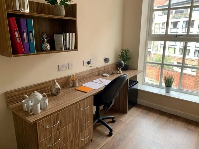 Desk with computer, chair, lamps and window study area. at Trinity Hall in Chester Student Accommodation