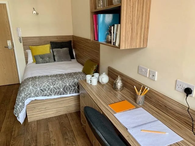 Bed desk and shelf with books bedroom at Trinity Hall in Chester Student Accommodation