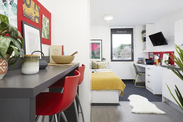 Red chairs desk and bed student accommodation bedroom at Athena Studios in Birmingham Student Accommodation