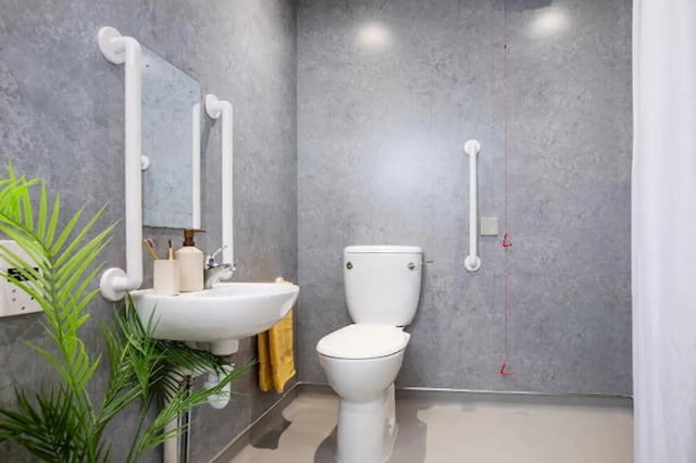 Toilet sink grab bars plant bathroom at Tramworks in Glasgow Student Accommodation