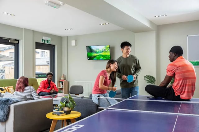 Ping pong tables and people playing ping pong lounge area at Tramworks in Glasgow Student Accommodation