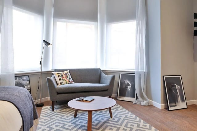 Grey sofa round table framed art living room at The Ballet School in Glasgow Student Accommodation