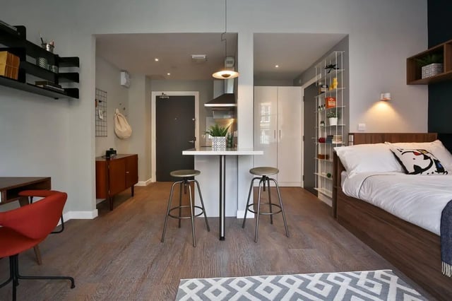 Bed desk kitchen and stools living area at The Ballet School in Glasgow Student Accommodation