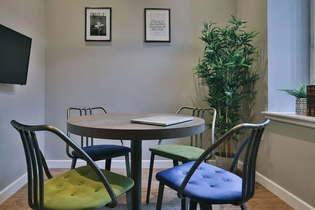 Round table laptop four chairs plant wall art study area at The Ballet School in Glasgow Student Accommodation