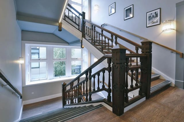 Wooden staircase with artwork and windows interior view at The Ballet School in Glasgow Student Accommodation