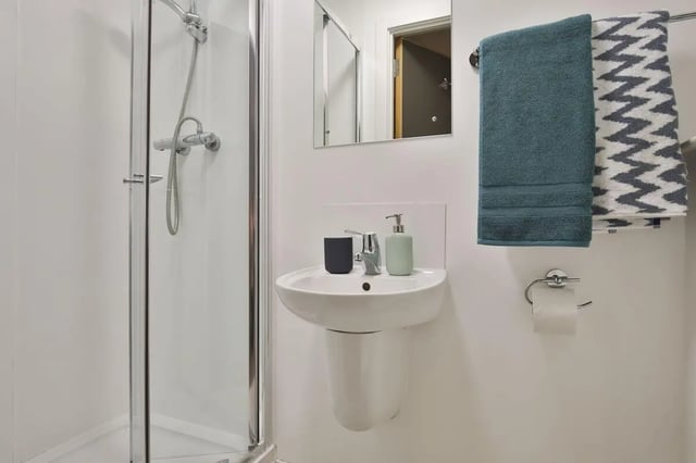 Shower sink dispenser soap towels mirror bathroom at Bath Street in Glasgow Student Accommodation