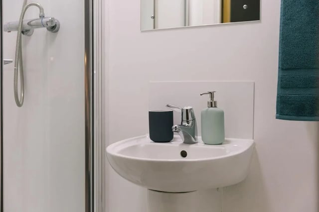 Sink shower dispenser and towel Bathroom at Bath Street in Glasgow Student Accommodation