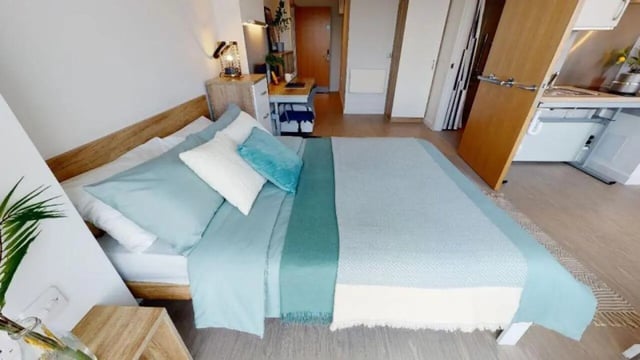 Bed desk lamp and kitchen area bedroom at iQ Elgin Place in Glasgow Student Accommodation