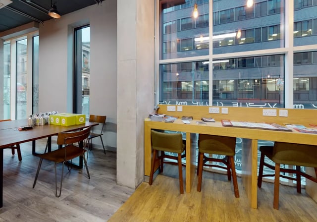 Table with green boxes chairs and desk Study area at iQ Elgin Place in Glasgow Student Accommodation