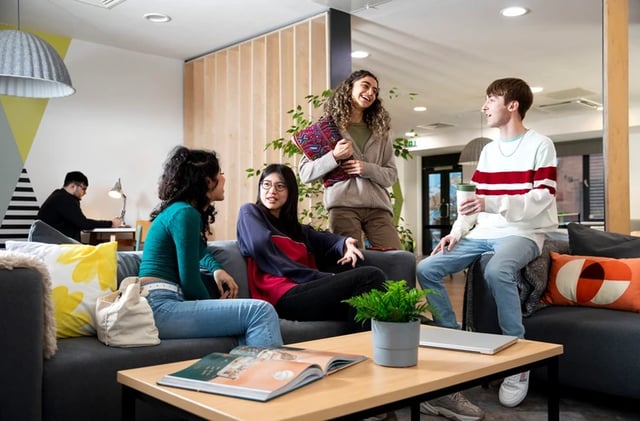 Students chatting on couches in communal living room at Brunel House in Bristol Student Accommodation