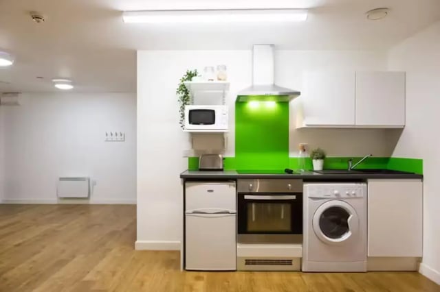 Compact kitchen with fridge oven washer microwave kitchen at St Lawrence House in Bristol Student Accommodation