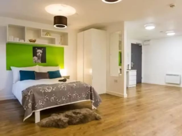 Bed with llama art and shelves bedroom at St Lawrence House in Bristol Student Accommodation