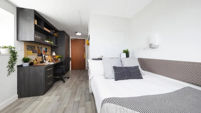 Desk and bed with pillows study area bedroom at Collegiate Tower in Bristol Student Accommodation