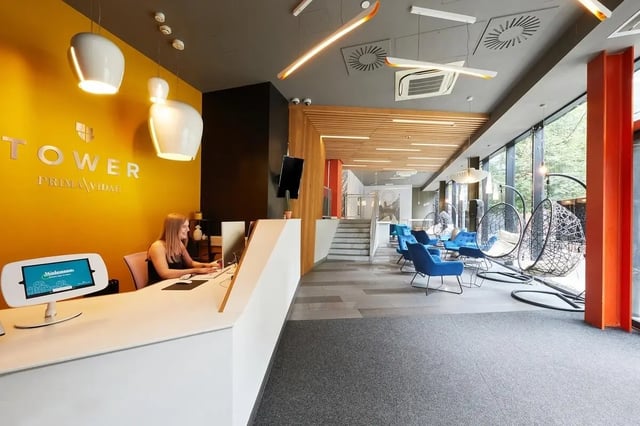 Reception desk computer screens lounge area exterior at Collegiate Tower in Bristol Student Accommodation