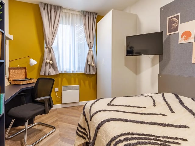 Desk chair TV and bed Bedroom at Yugo Belaton House in Bournemouth Student Accommodation