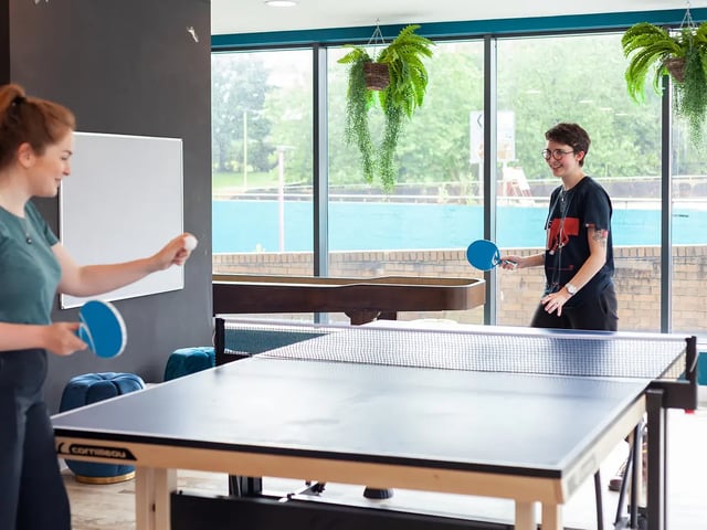 Students playing ping pong table tennis area at Yugo Belaton House in Bournemouth Student Accommodation