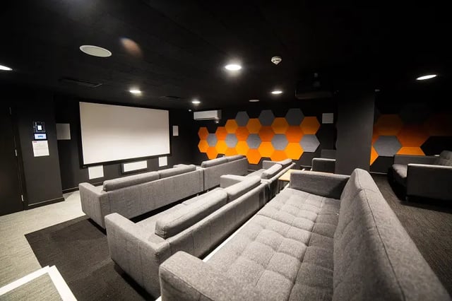 Grey sofas arranged in a cinema room at AXO Paradise Student Village in Coventry Student Accommodation