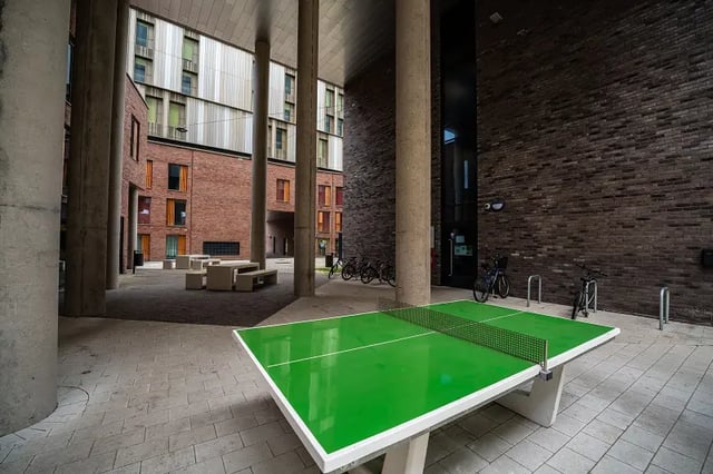 Green ping pong table bikes outdoor seating exterior at AXO Paradise Student Village in Coventry Student Accommodation