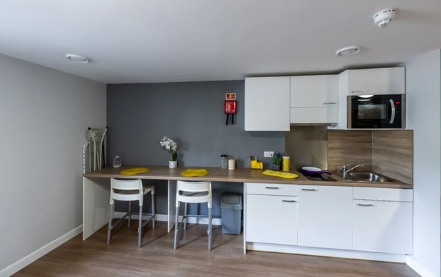 Two white stools at breakfast bar kitchen at Haddington Place in Edinburgh Student Accommodation