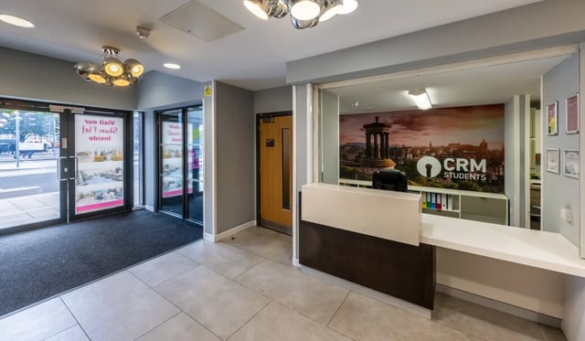 Reception desk with branding and entrance Image Entrance at Haddington Place in Edinburgh Student Accommodation
