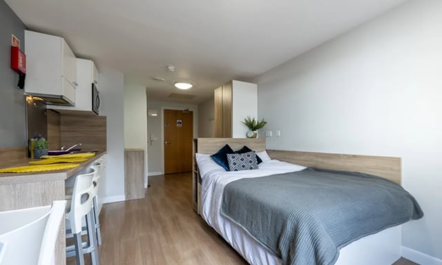 Bed kitchen and doorway student accommodation room at Haddington Place in Edinburgh Student Accommodation