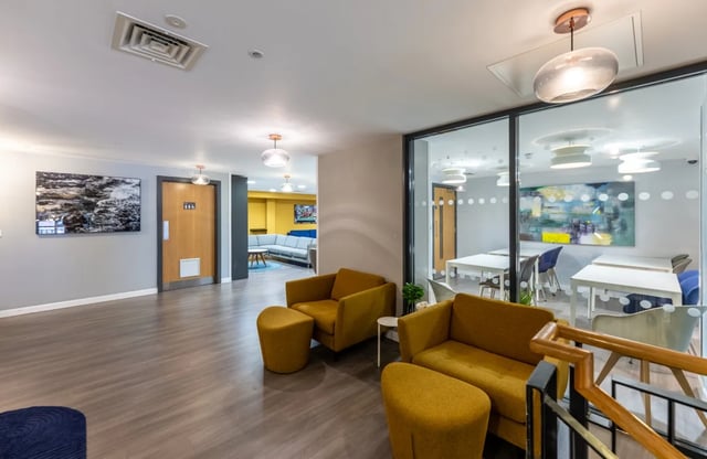 Yellow armchairs and ottomans in common area at Haddington Place in Edinburgh Student Accommodation