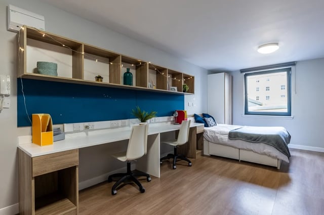 Two desks bed and shelving student accommodation bedroom at Haddington Place in Edinburgh Student Accommodation