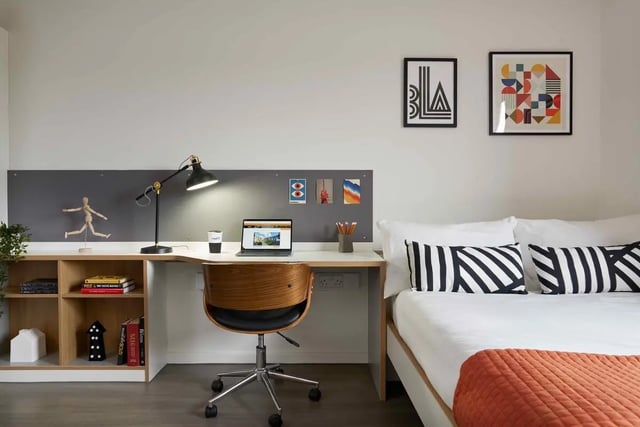Desk lamp laptop bed with striped pillows Bedroom at Asa Briggs House in Leeds Student Accommodation