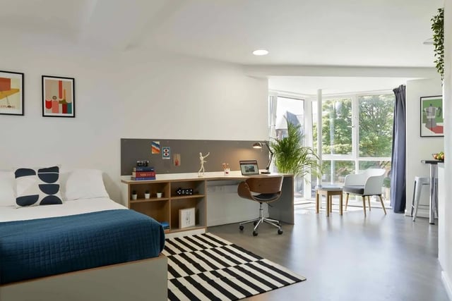 Bed desk chair and large windows studio apartment at Asa Briggs House in Leeds Student Accommodation