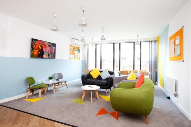 Colorful couches and chairs in communal living room at Broadcasting Tower in Leeds Student Accommodation